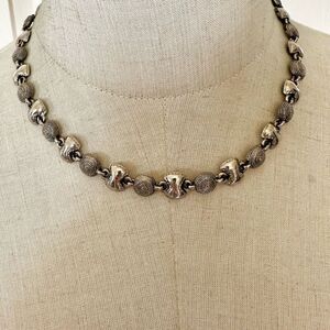 Silver tone circle bow necklace